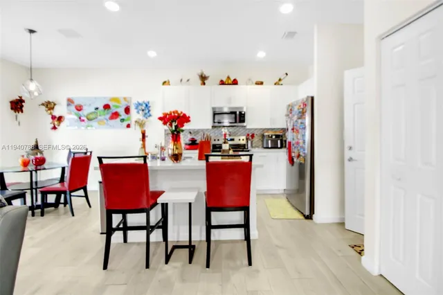 a living room with furniture a dining table and a sink