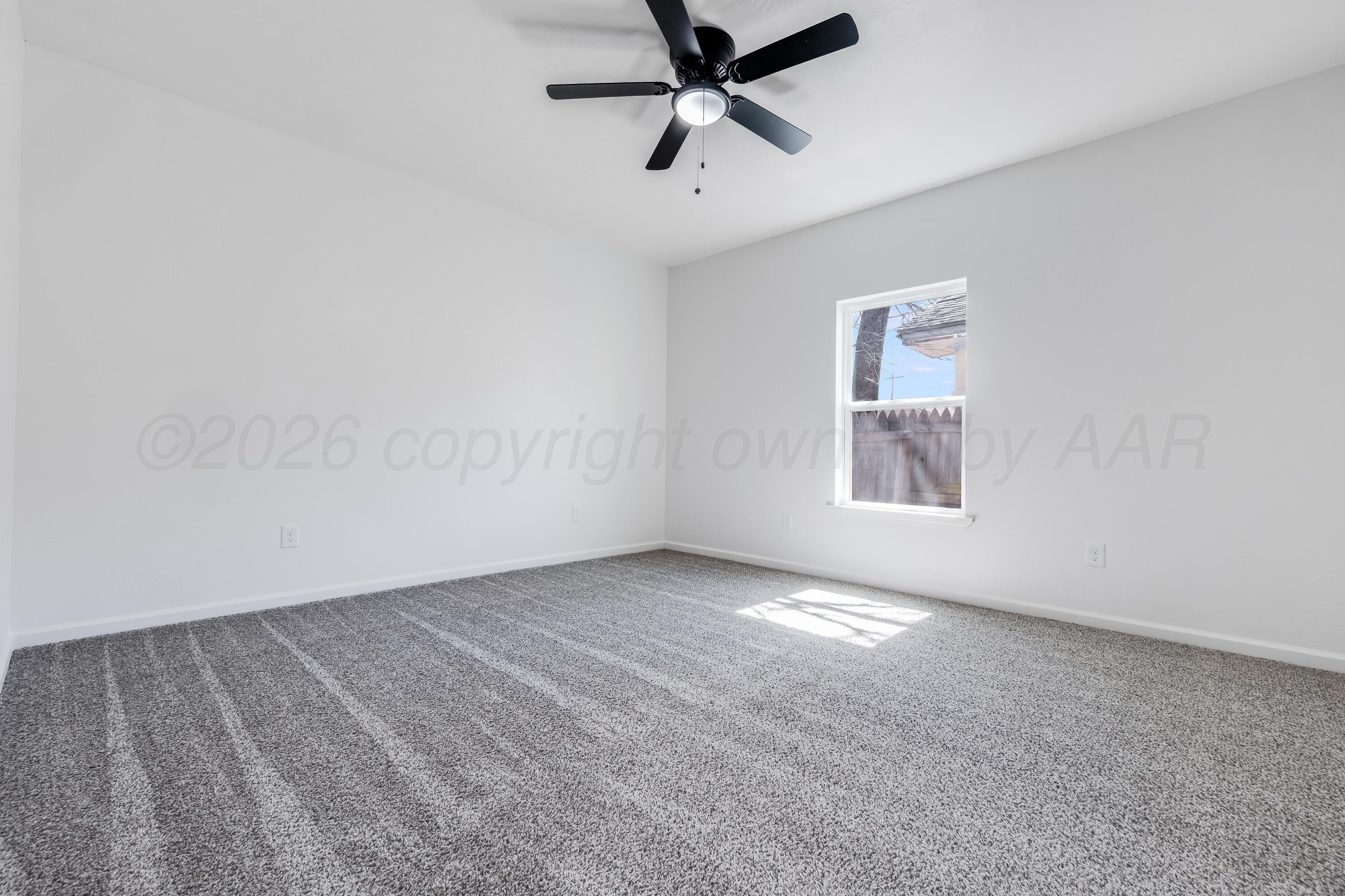 409 South Forest Street Amarillo, TX 79106 - Photo 15 of 18 an empty room with a window and a fan