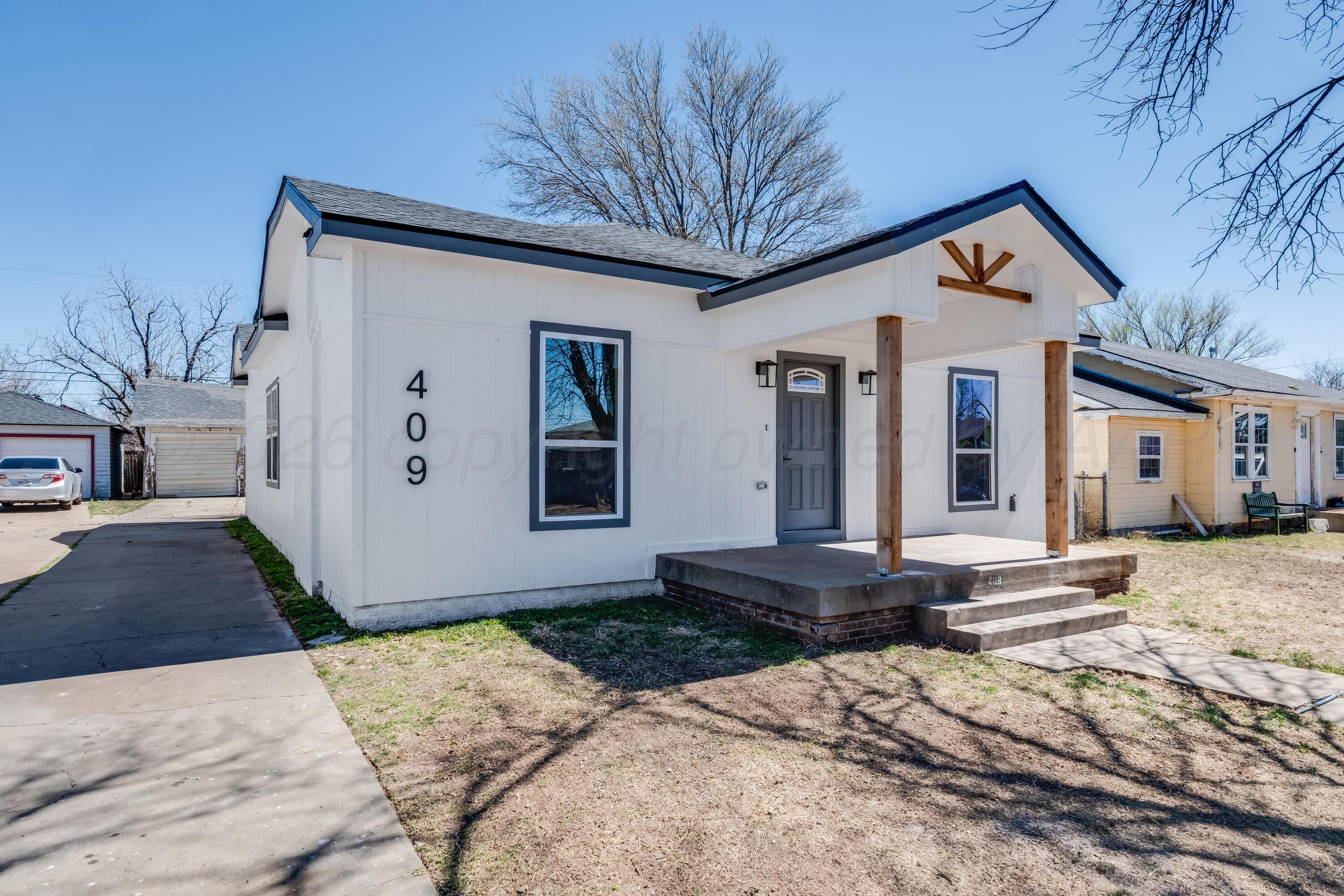 409 South Forest Street Amarillo, TX 79106 - Photo 18 of 18 a front view of a house with a yard and garage
