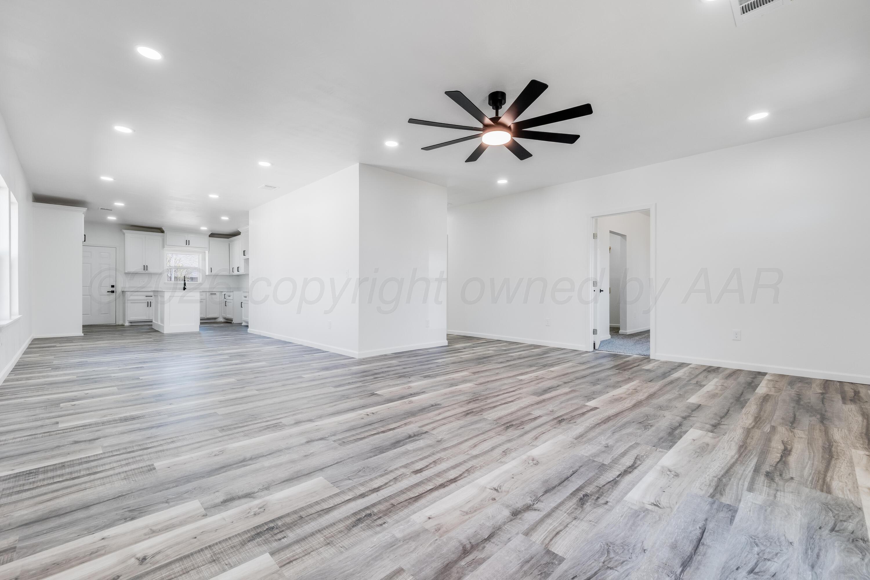 409 South Forest Street Amarillo, TX 79106 - Photo 3 of 18 a view of empty room with wooden floor and window