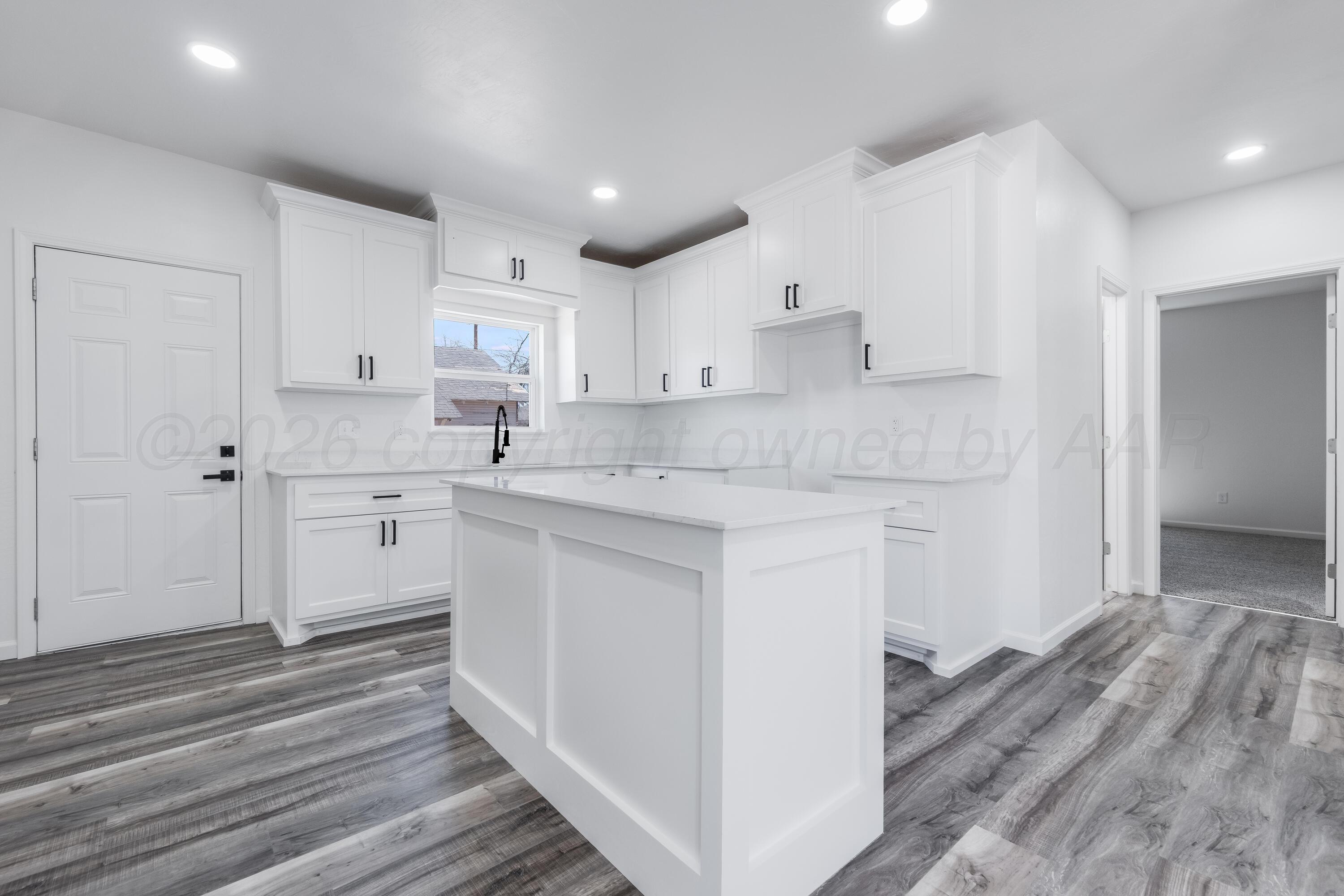 409 South Forest Street Amarillo, TX 79106 - Photo 5 of 18 a kitchen with granite countertop white cabinets and white appliances