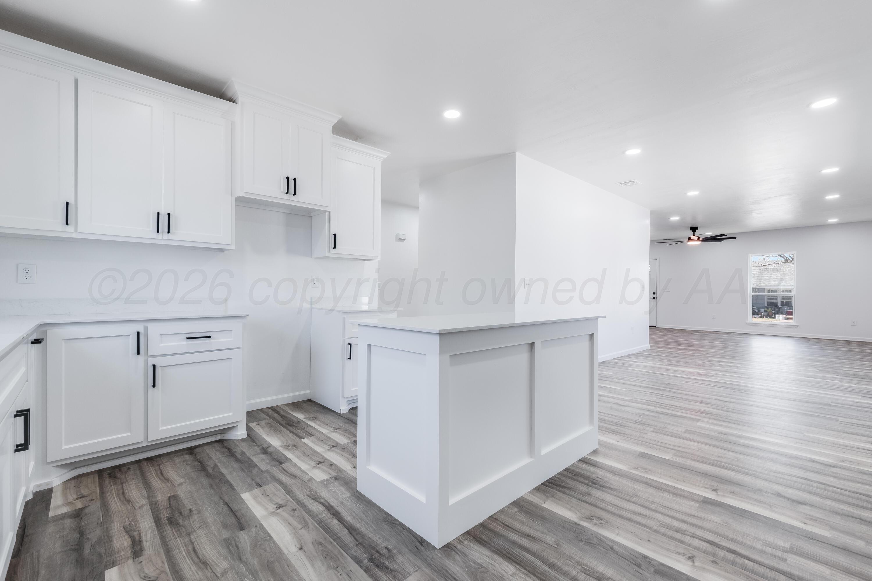 409 South Forest Street Amarillo, TX 79106 - Photo 6 of 18 a kitchen with a white wooden cabinets and stove top oven