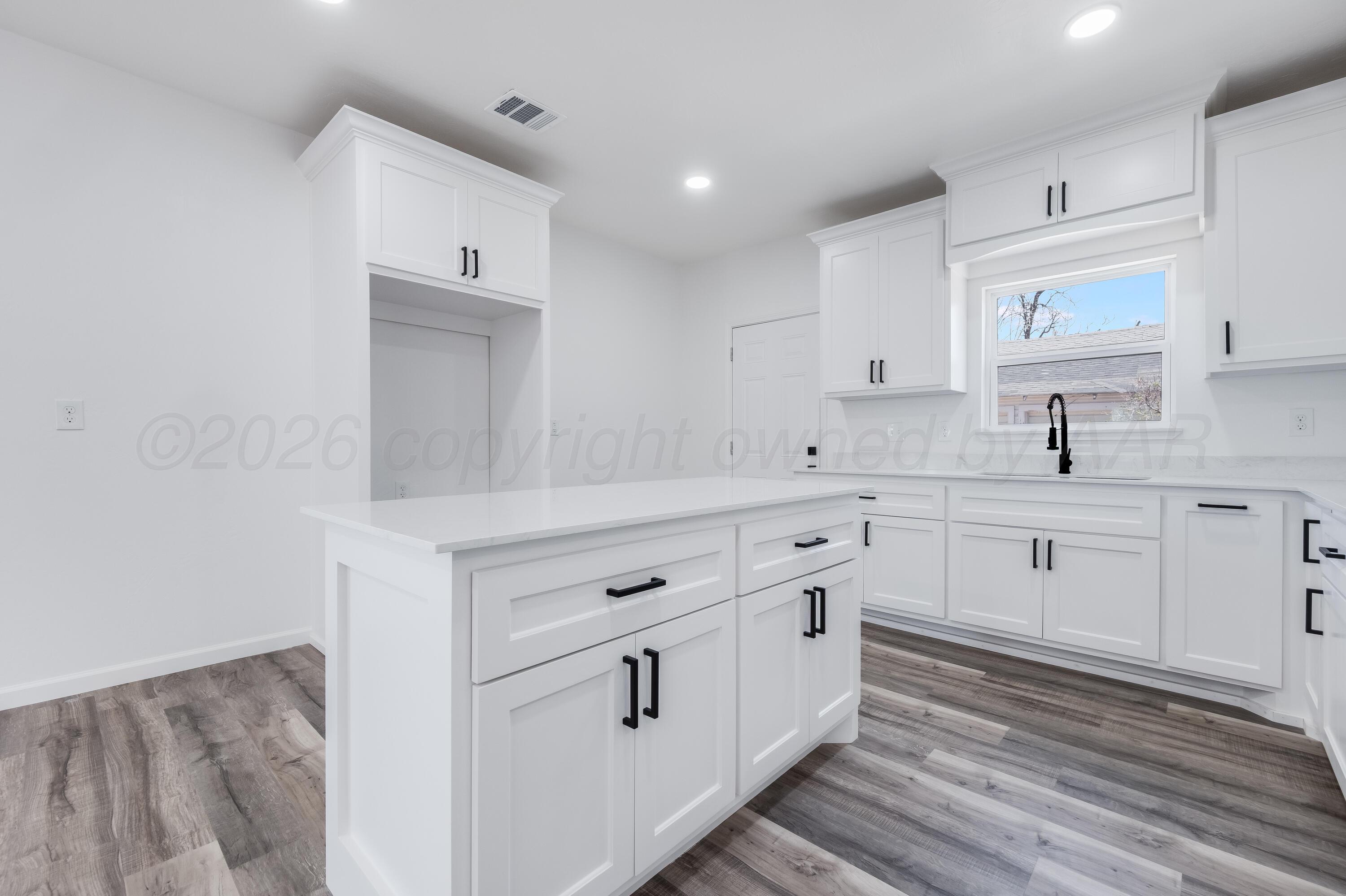 409 South Forest Street Amarillo, TX 79106 - Photo 8 of 18 a kitchen with white cabinets stainless steel appliances and sink