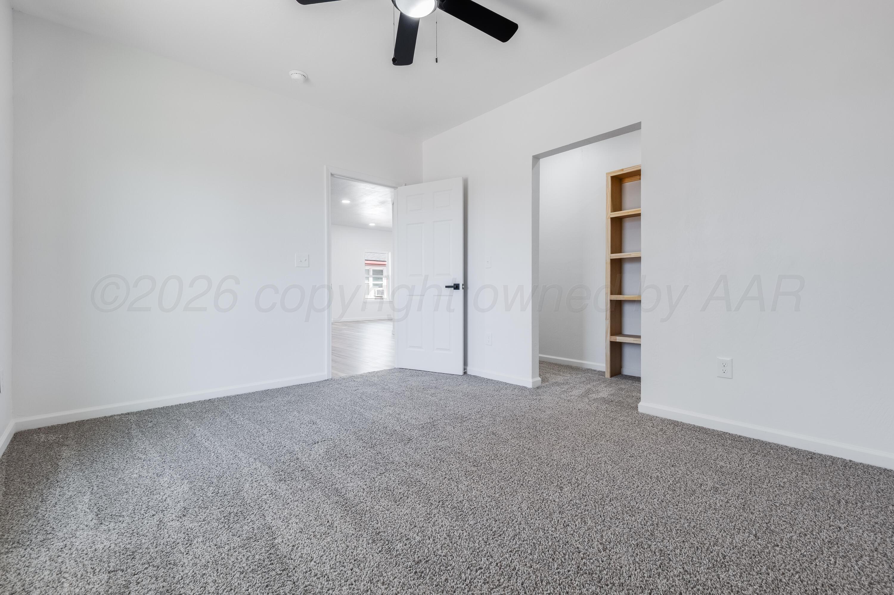 409 South Forest Street Amarillo, TX 79106 - Photo 10 of 18 an empty room with closet and windows