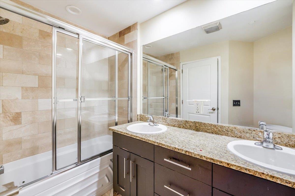 29 1st Street, Unit 408 Hackensack, NJ 07601 - Photo 19 of 29 a bathroom with a granite countertop sink and a mirror