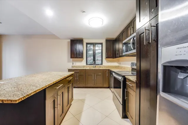 a kitchen with stainless steel appliances granite countertop a sink and stove