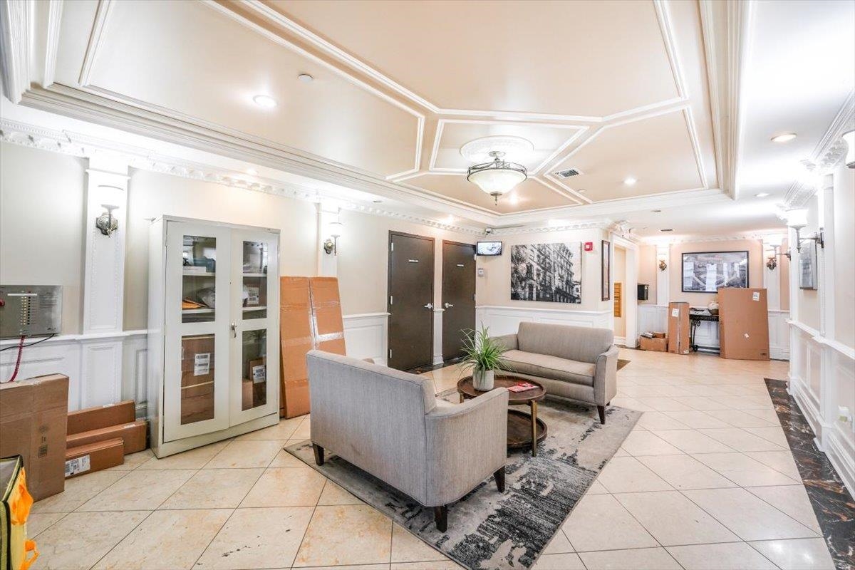 29 1st Street, Unit 408 Hackensack, NJ 07601 - Photo 22 of 29 a living room with furniture and a large window