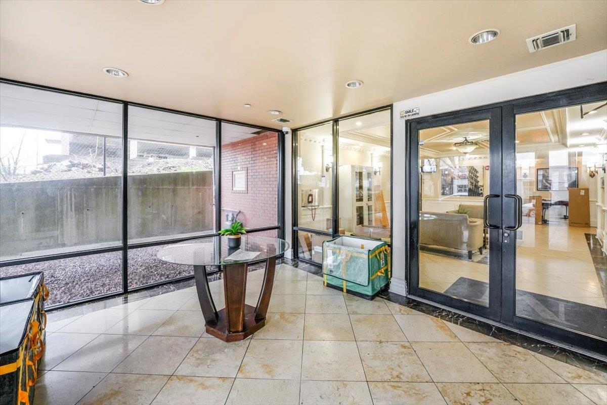 29 1st Street, Unit 408 Hackensack, NJ 07601 - Photo 23 of 29 a lobby with a glass door and glass door