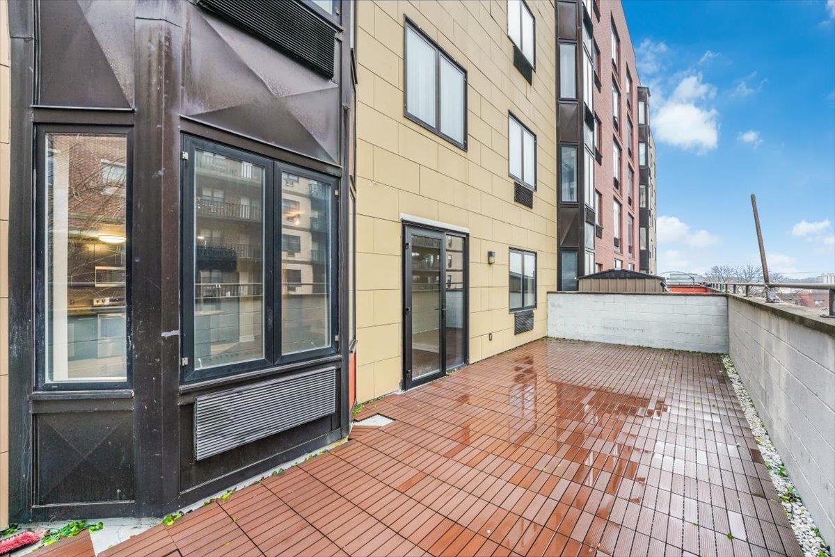 29 1st Street, Unit 408 Hackensack, NJ 07601 - Photo 26 of 29 a view of a brick house with a outdoor space
