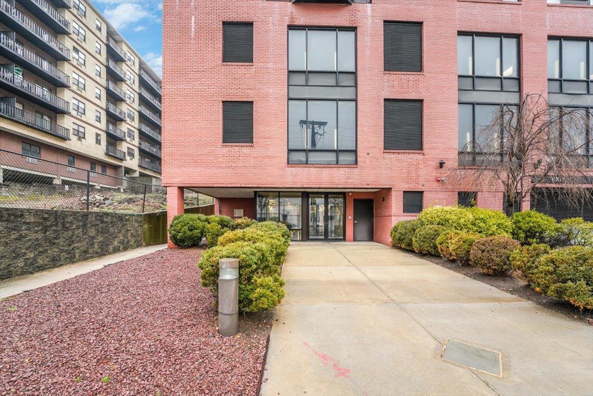 29 1st Street, Unit 408 Hackensack, NJ 07601 - Photo 27 of 29 a front view of a building with garden