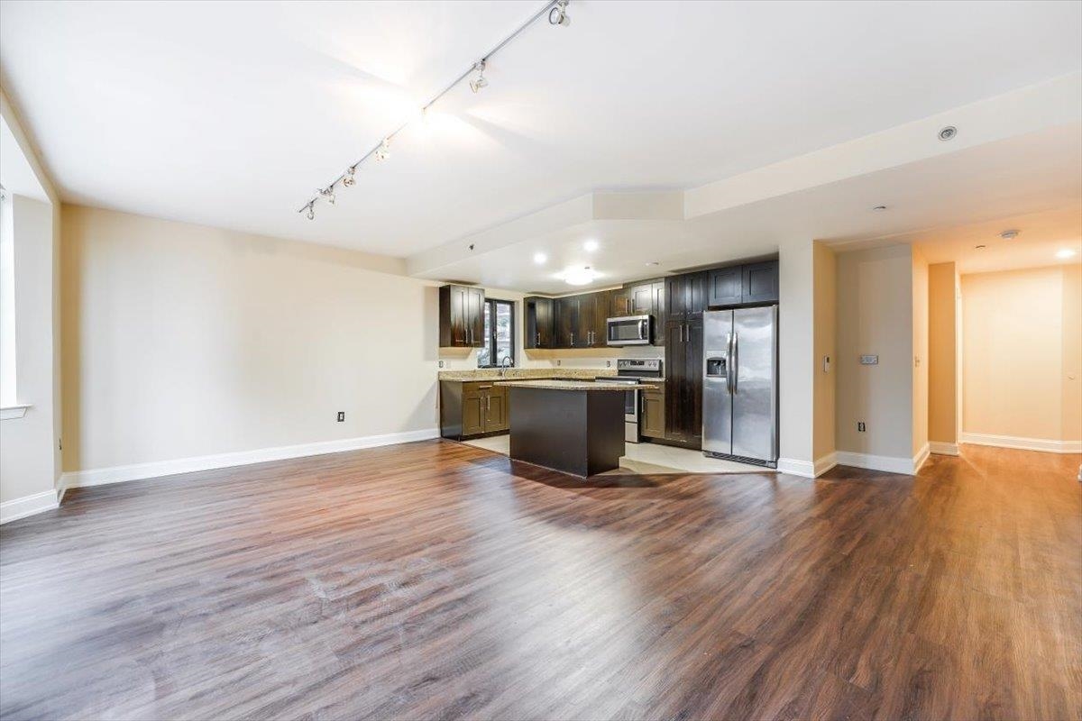 29 1st Street, Unit 408 Hackensack, NJ 07601 - Photo 5 of 29 a view of a kitchen with a sink a refrigerator and a stove top oven
