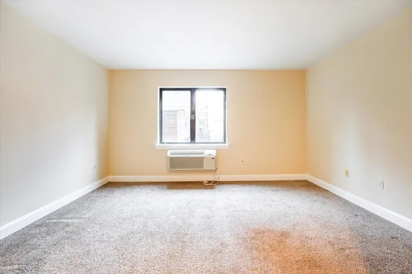 a view of an empty room and a window