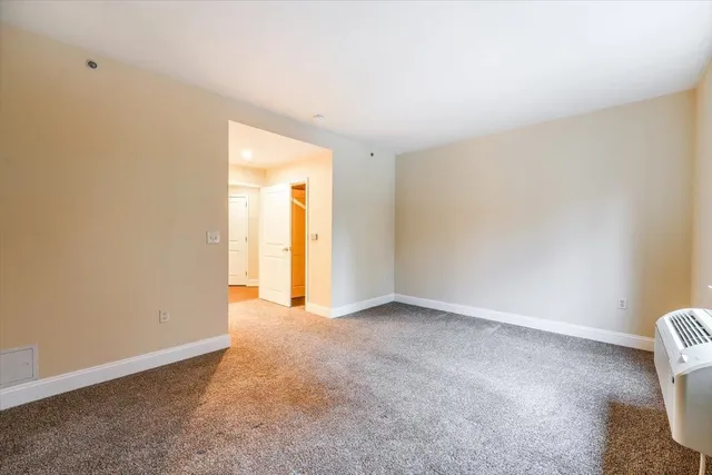 a view of an empty room and a window