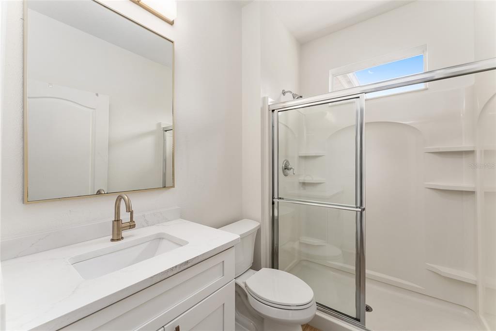 4987 Southwest 63rd Loop Ocala, FL 34474 - Photo 43 of 56 a bathroom with a sink a toilet and shower