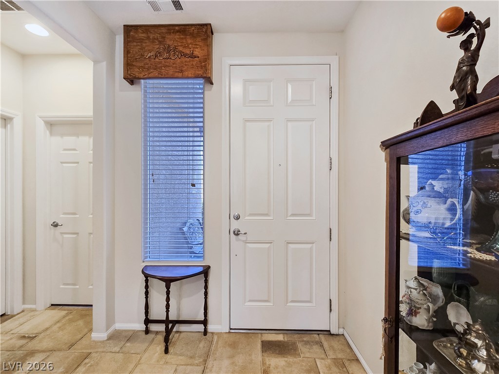 2485 Morrow Ridge Place Laughlin, NV 89029 - Photo 6 of 40 A well-lit entry hall features durable tile flooring, providing a welcoming atmosphere.