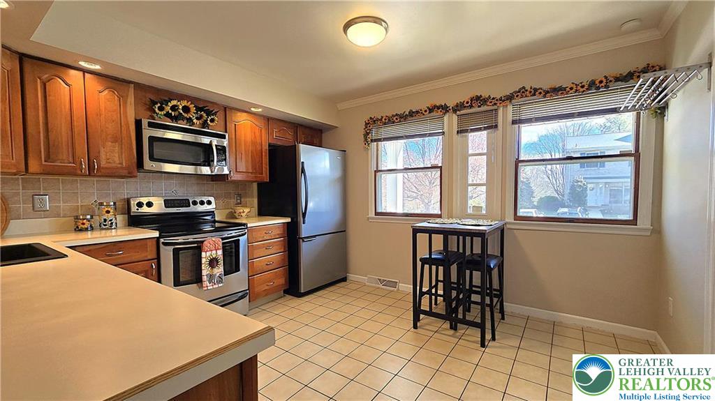 194 Springhouse Road Allentown, PA 18104 - Photo 10 of 34 This bright kitchen features ample counter space and offers a perfect spot for casual dining.