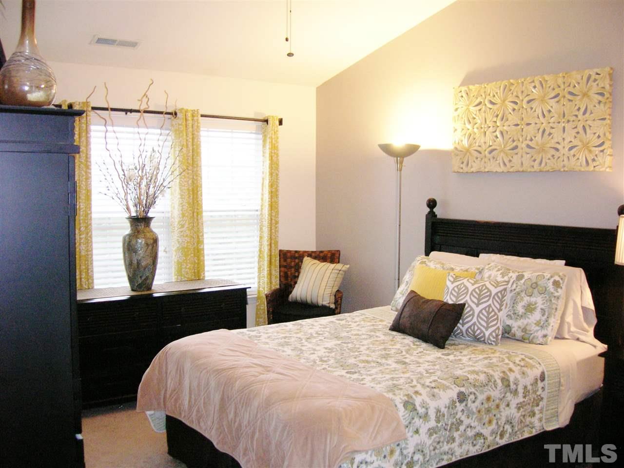 8308 City Loft Court Raleigh, NC 27613 - Photo 14 of 23 a bedroom with a bed and window
