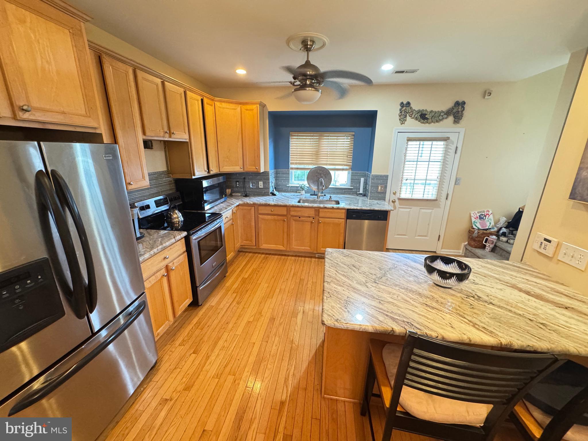 20 Wilson Way Delanco, NJ 08075 - Photo 33 of 38 a kitchen with a table chairs refrigerator and a sink