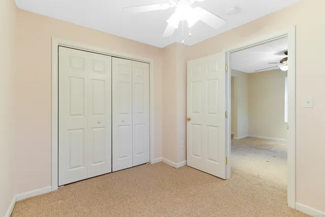 an empty room with a ceiling fan