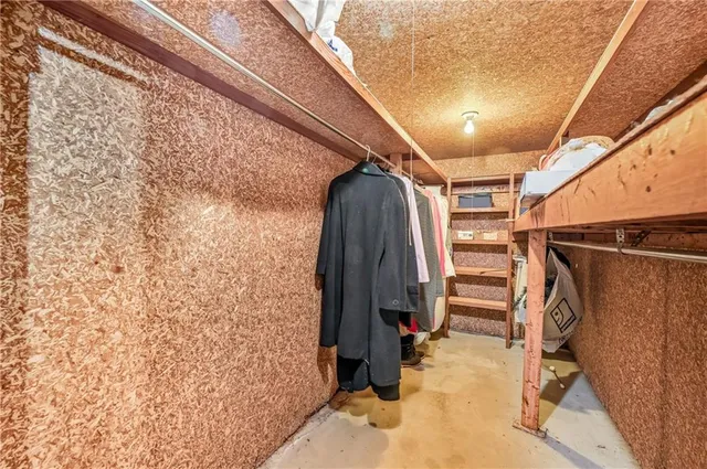 a view of walk in closet with clothes