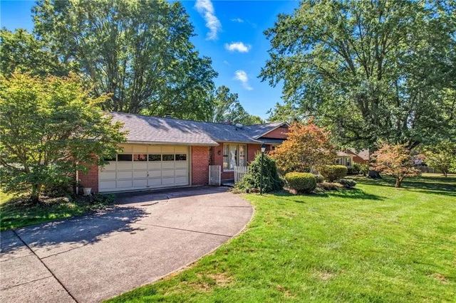 a view of a house with a yard and tree