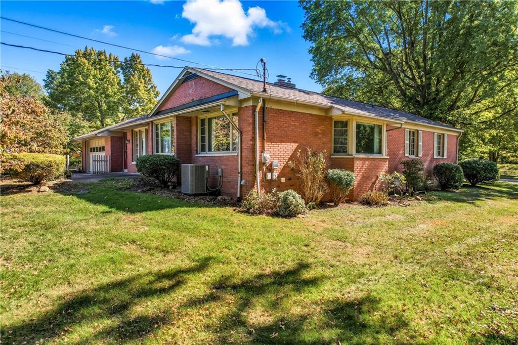 400 Hazen Road Sharpsville, PA 16150 - Photo 4 of 49 a view of a yard in front of a house with plants and large tree