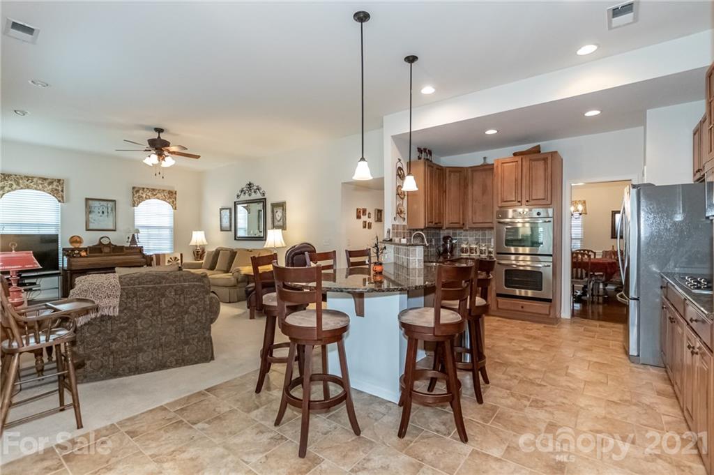 7116 Meyer Road Fort Mill, SC 29715 - Photo 16 of 31 a living room with lots of furniture and a chandelier
