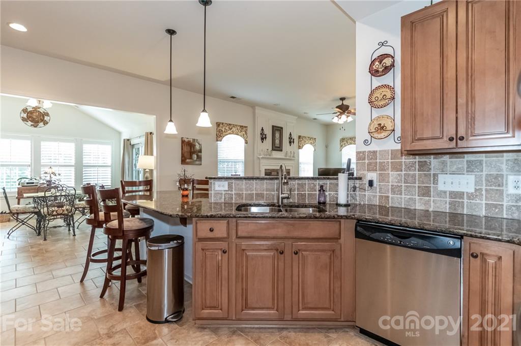 7116 Meyer Road Fort Mill, SC 29715 - Photo 17 of 31 a kitchen with stainless steel appliances granite countertop a stove a sink dishwasher and a wooden cabinets