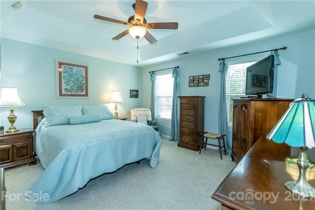 7116 Meyer Road Fort Mill, SC 29715 - Photo 19 of 31 a spacious bedroom with a bed and a flat screen tv