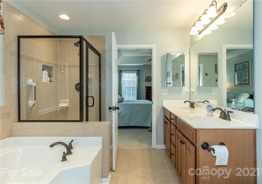 7116 Meyer Road Fort Mill, SC 29715 - Photo 20 of 31 a bathroom with a tub sink and mirror