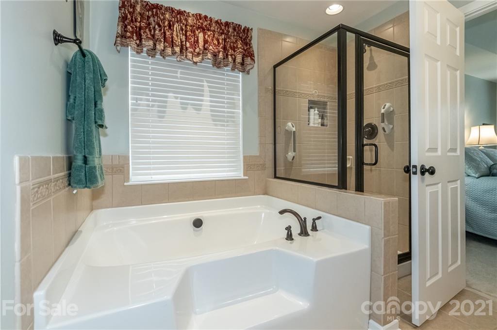 7116 Meyer Road Fort Mill, SC 29715 - Photo 21 of 31 a bathroom with a bathtub and a shower
