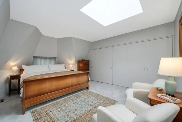 a bedroom with furniture and a lamp