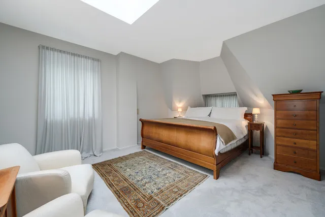 a bedroom with a bed and a couch