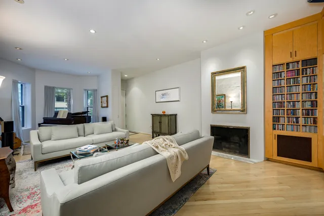 a living room with furniture window and a fireplace