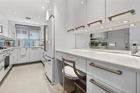 a kitchen with a sink stainless steel appliances and cabinets
