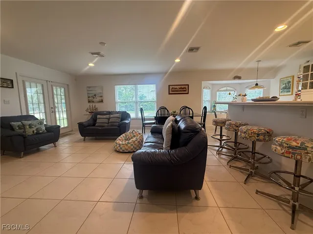 a living room with furniture and kitchen view