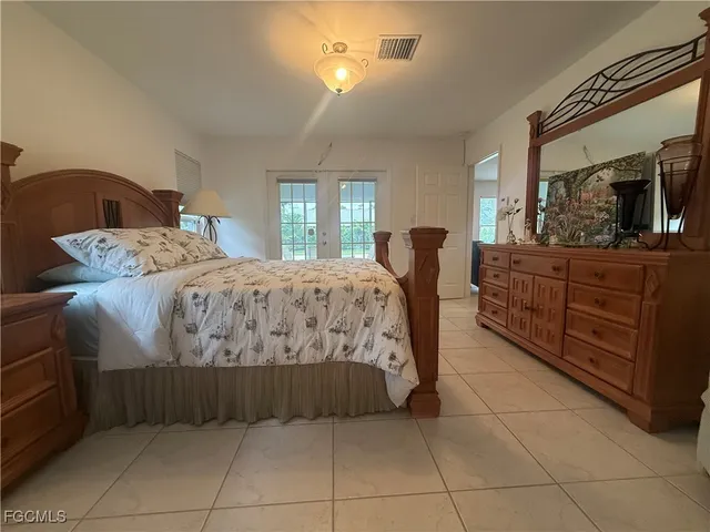 a living room with furniture chandelier and a window
