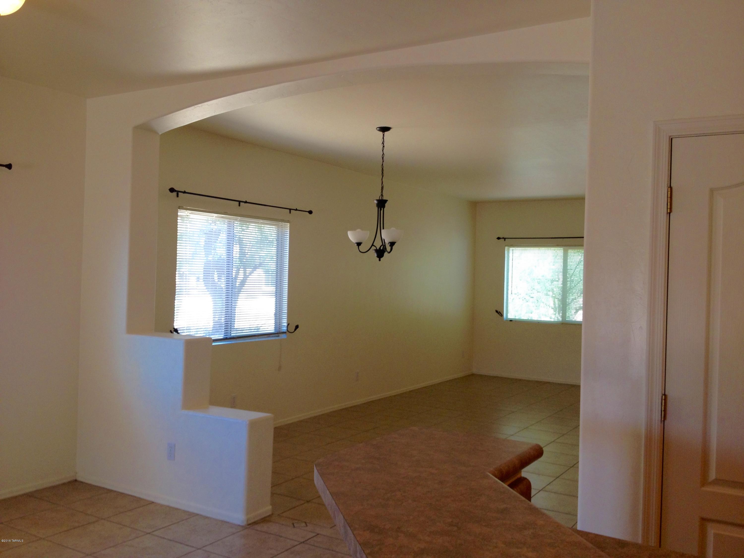7931 North Iron Ridge Drive Tucson, AZ 85743 - Photo 6 of 21 an empty room with windows