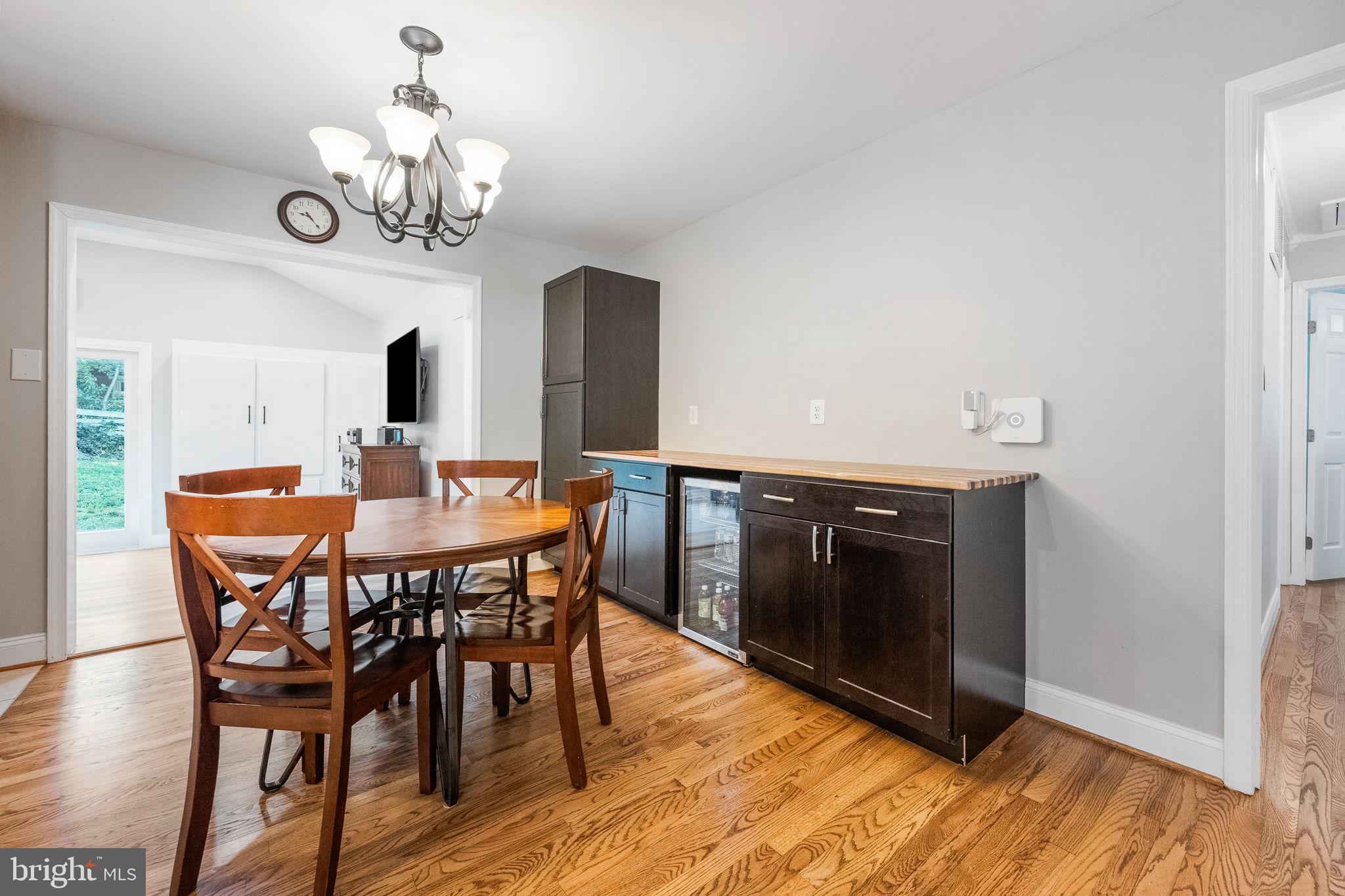 7203 Hadlow Drive Springfield, VA 22152 - Photo 12 of 39 a view of a dining room with furniture wooden floor and chandelier