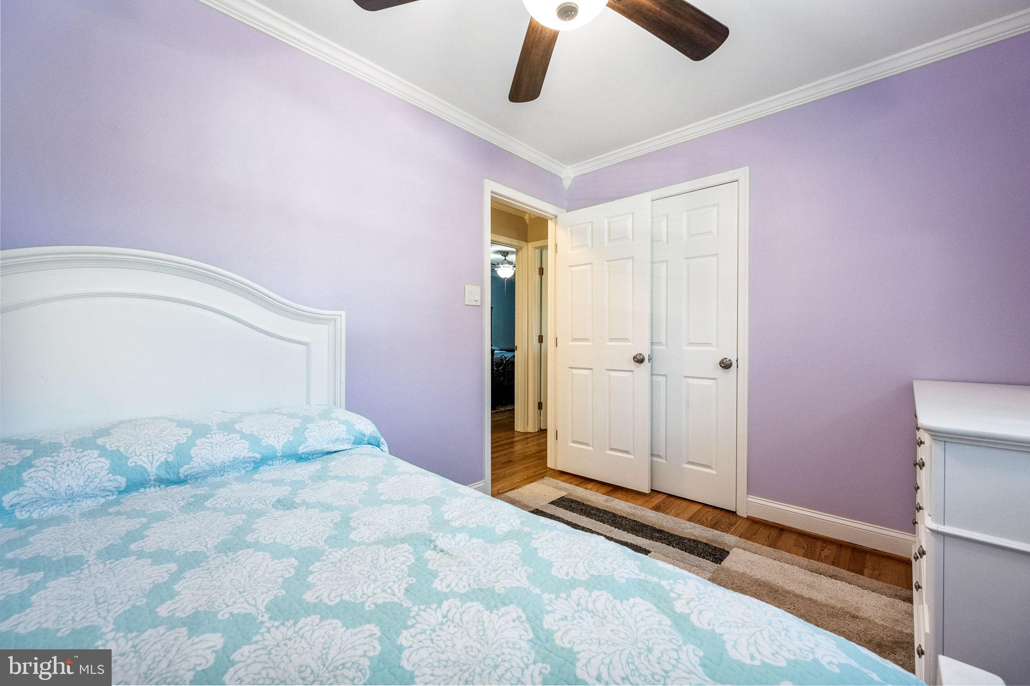 7203 Hadlow Drive Springfield, VA 22152 - Photo 17 of 39 a bedroom with a bed and a chandelier