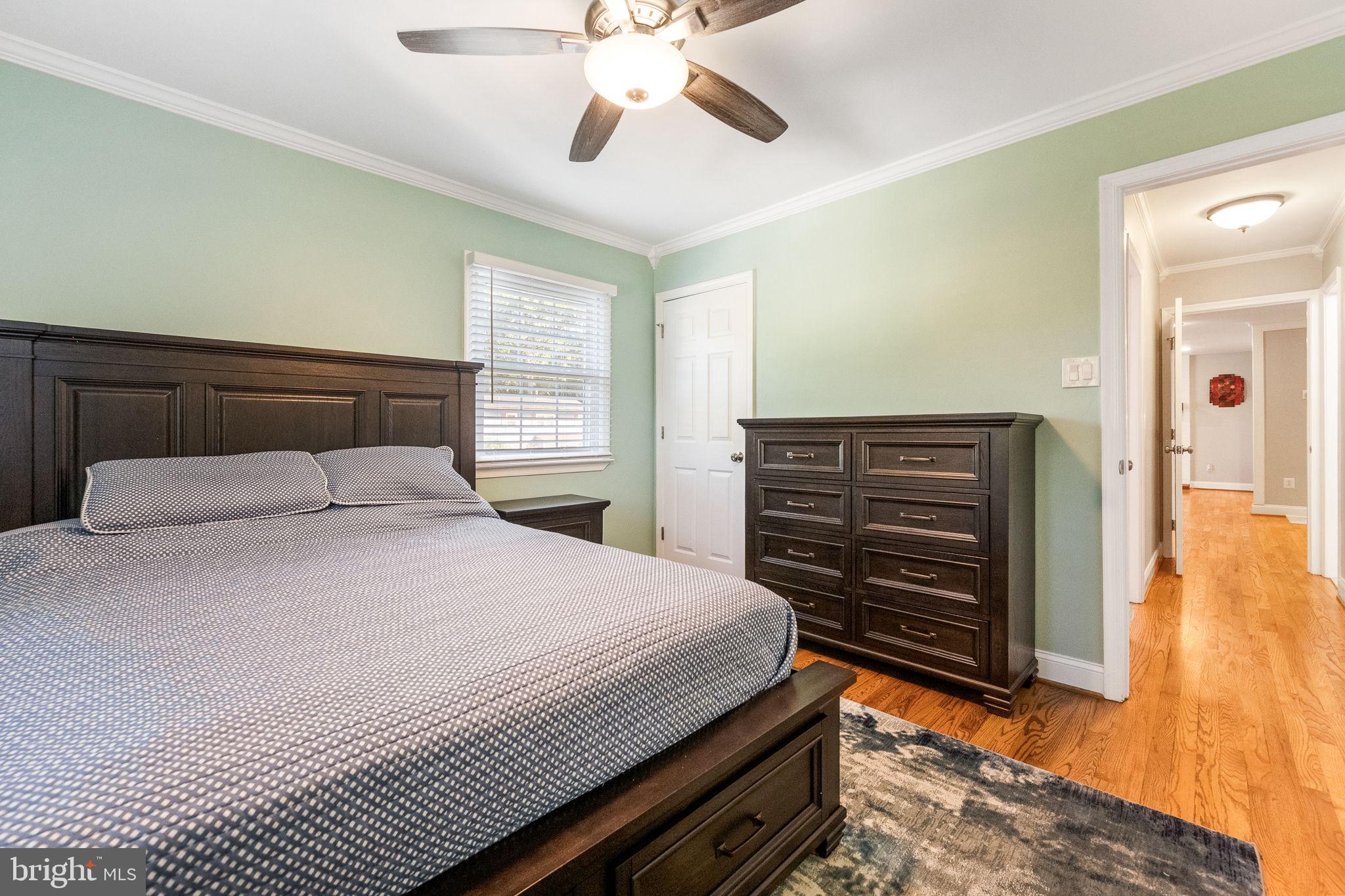 7203 Hadlow Drive Springfield, VA 22152 - Photo 20 of 39 a bedroom with a bed and wooden floor