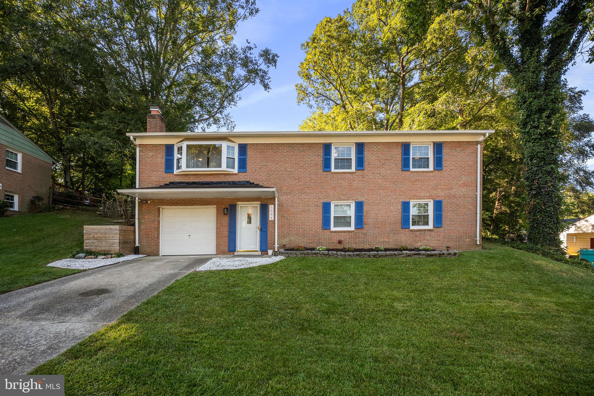 7203 Hadlow Drive Springfield, VA 22152 - Photo 2 of 39 a front view of a house with a garden and yard