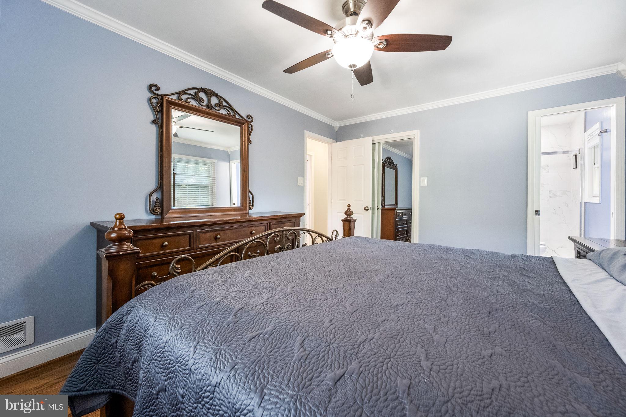 7203 Hadlow Drive Springfield, VA 22152 - Photo 22 of 39 a bedroom with a bed and a chandelier