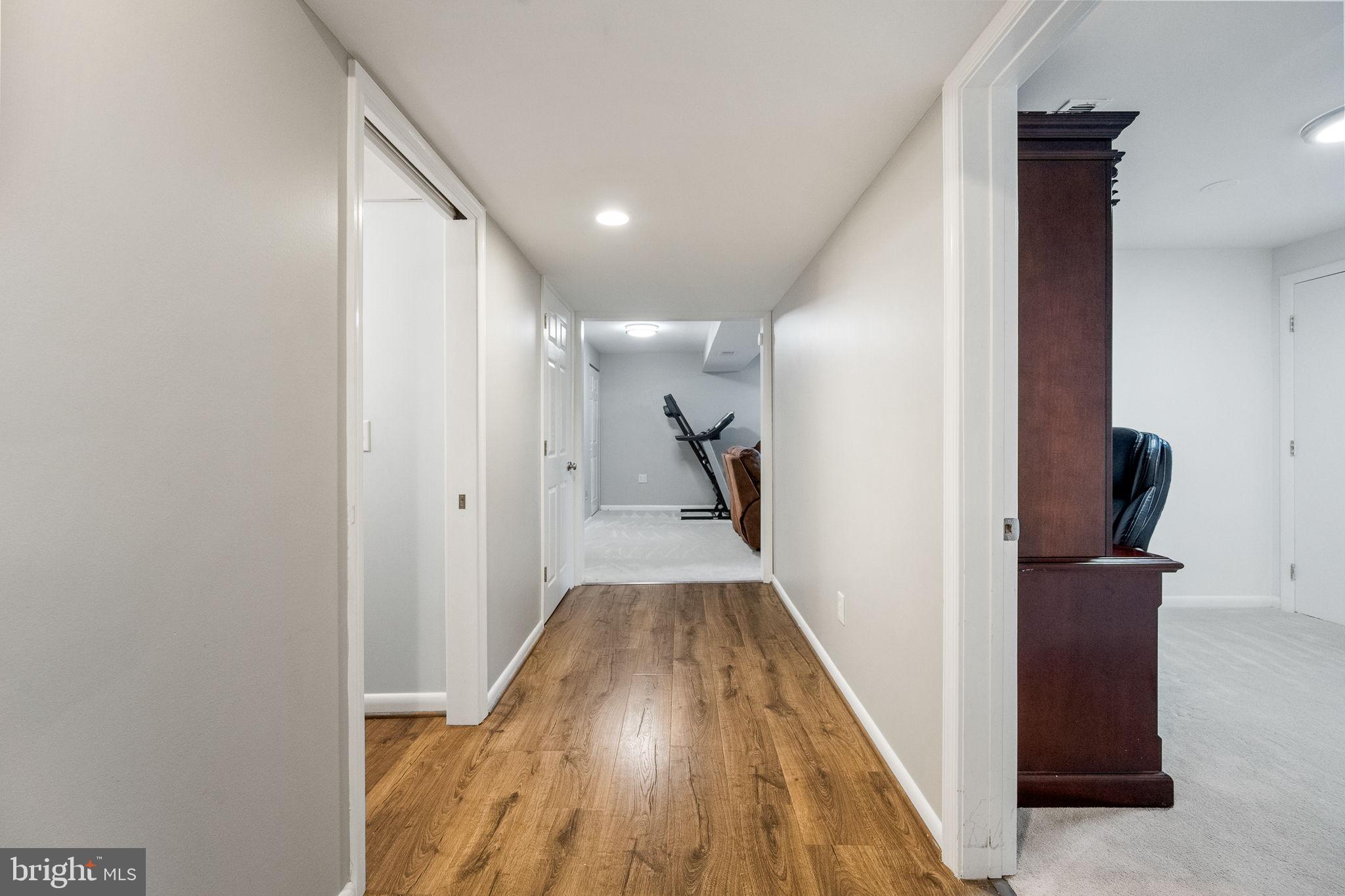 7203 Hadlow Drive Springfield, VA 22152 - Photo 26 of 39 a view of a hallway with wooden floor and staircase