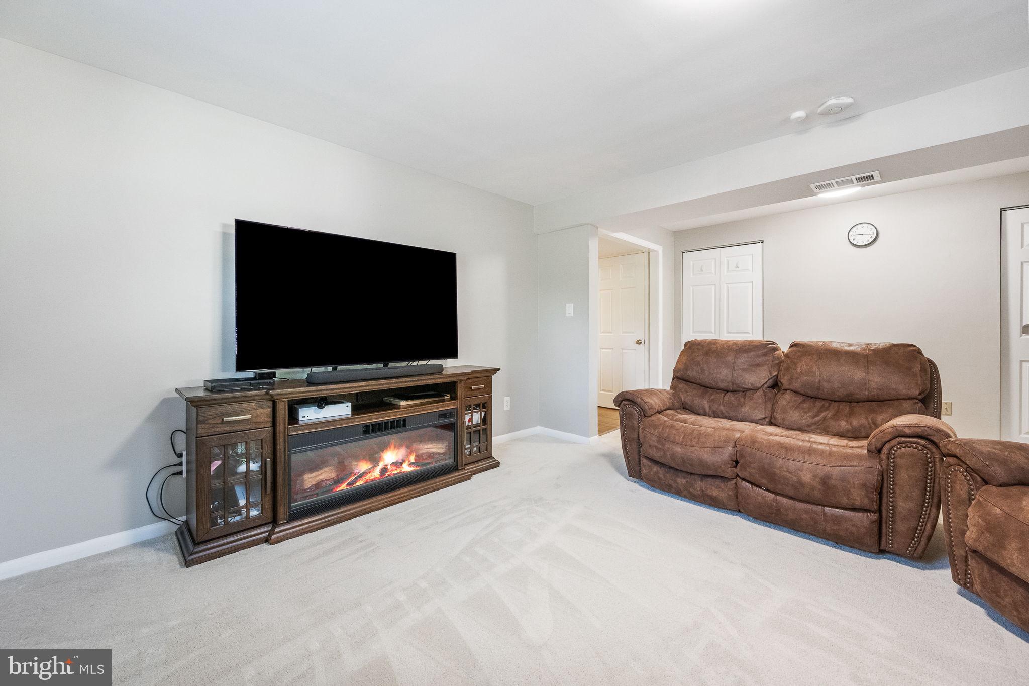 7203 Hadlow Drive Springfield, VA 22152 - Photo 30 of 39 a living room with furniture and a flat screen tv