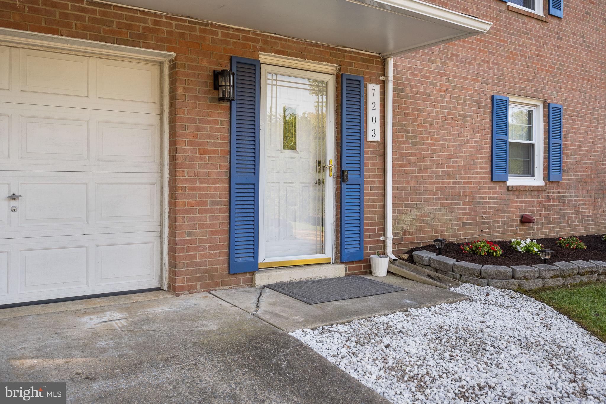 7203 Hadlow Drive Springfield, VA 22152 - Photo 5 of 39 a front view of a house with garden