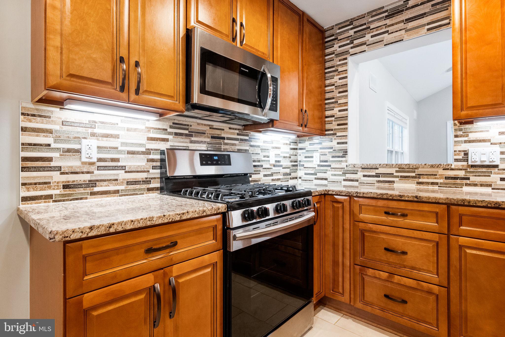 7203 Hadlow Drive Springfield, VA 22152 - Photo 6 of 39 a kitchen with granite countertop cabinets stainless steel appliances and a sink