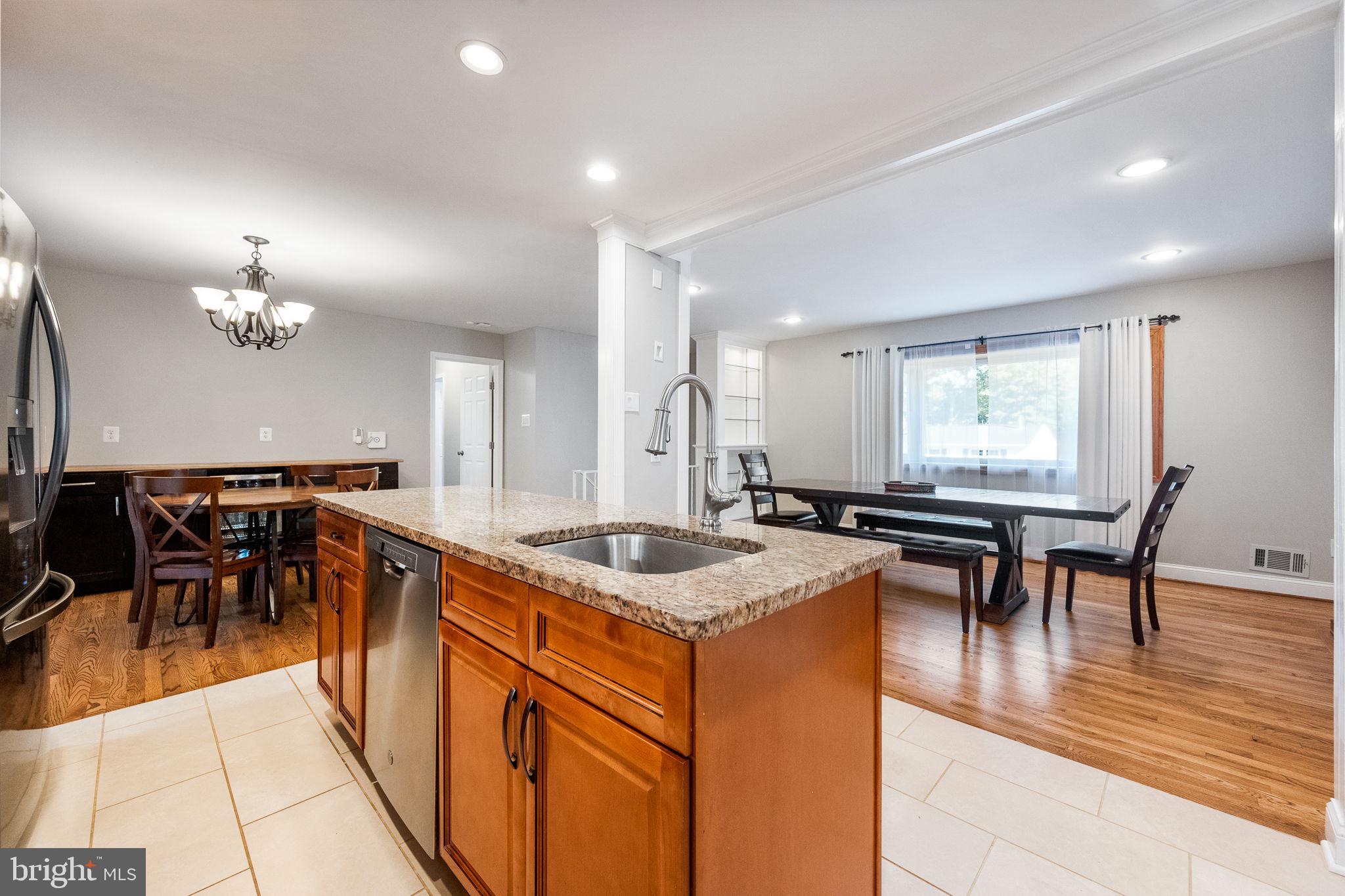 7203 Hadlow Drive Springfield, VA 22152 - Photo 7 of 39 a kitchen with stainless steel appliances granite countertop counter space a dining table and chairs