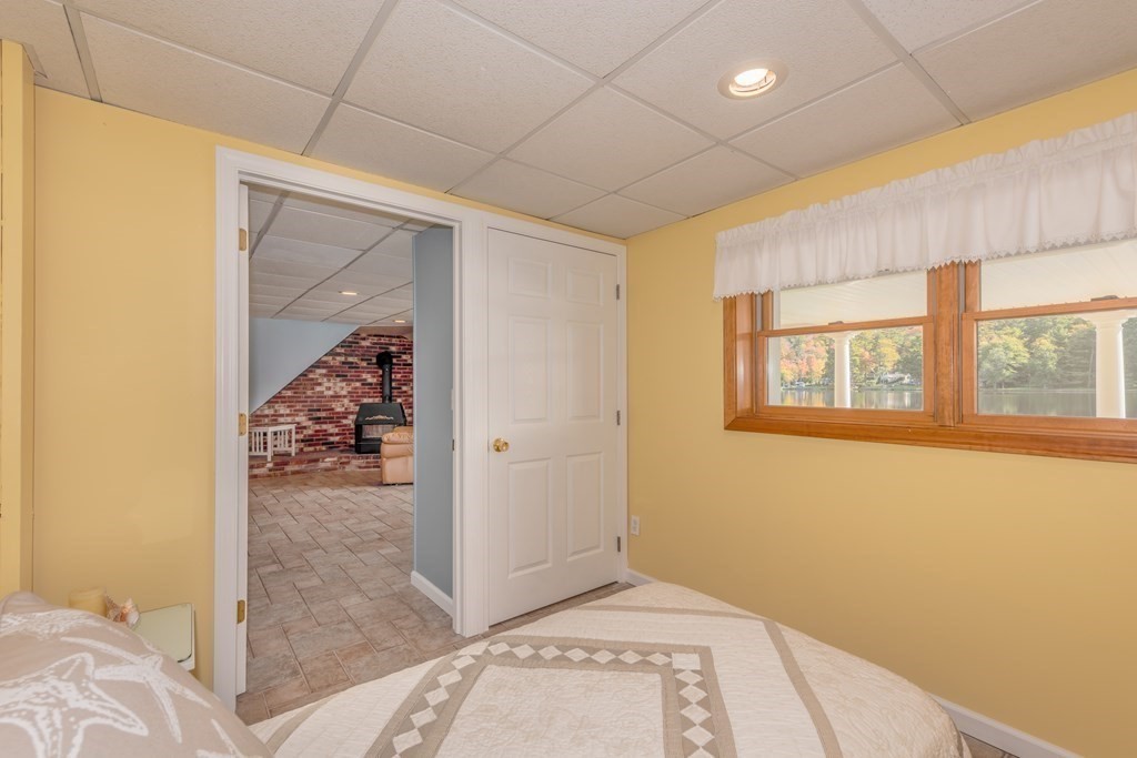 23 Craig Road Holland, MA 01521 - Photo 18 of 40 a view of hallway with a bed and wooden floor