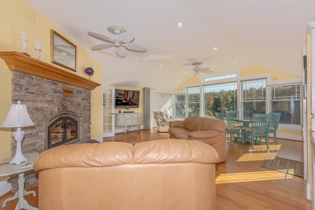 23 Craig Road Holland, MA 01521 - Photo 4 of 40 a living room with furniture a fireplace and a floor to ceiling window